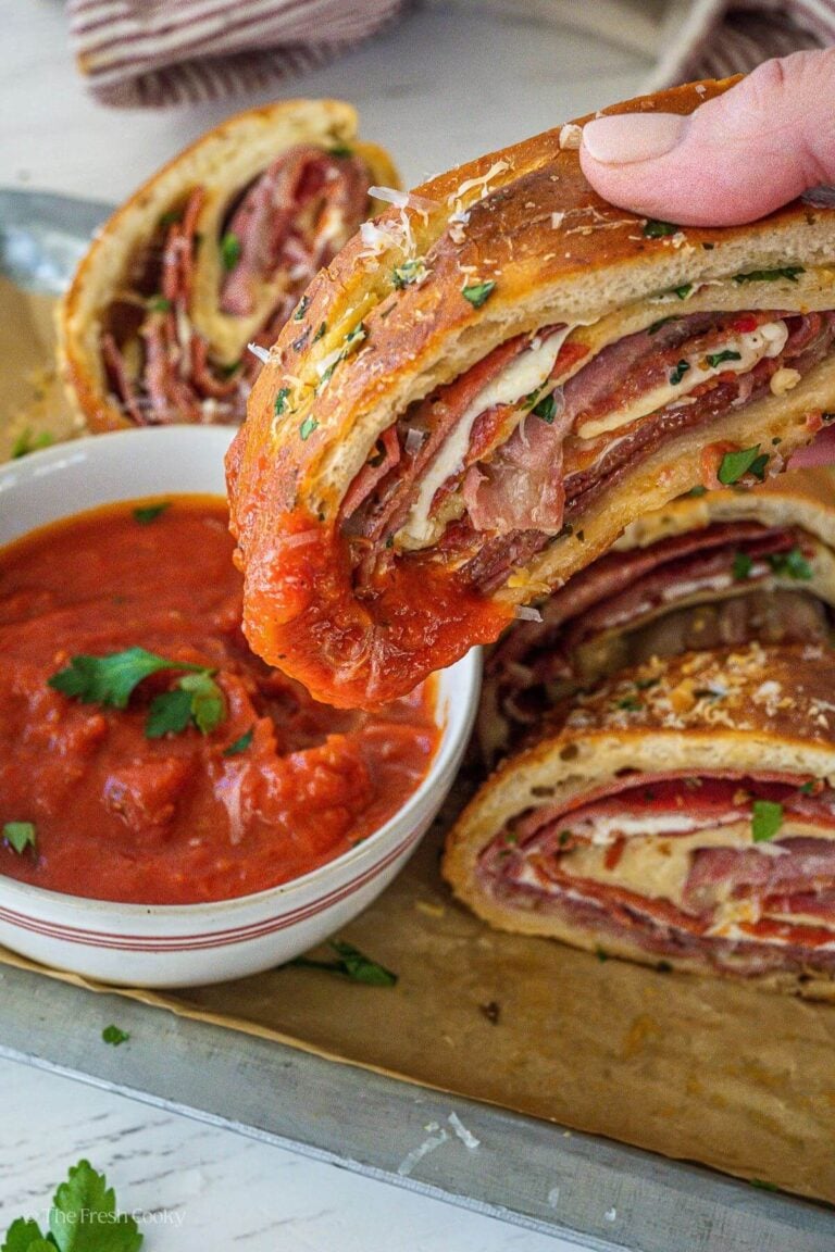 Dipping stromboli into marinara sauce.