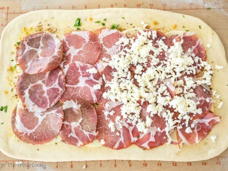 Add capicola and any meats and top with shredded mozzarella.