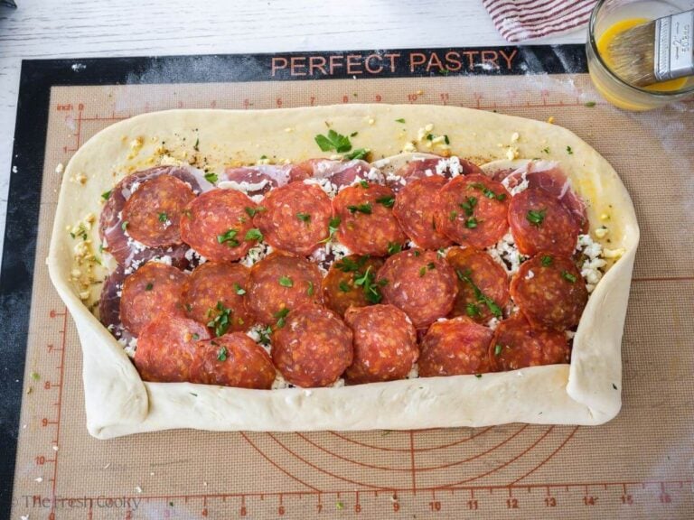How to roll stromboli, turn edges up and fold in sides.