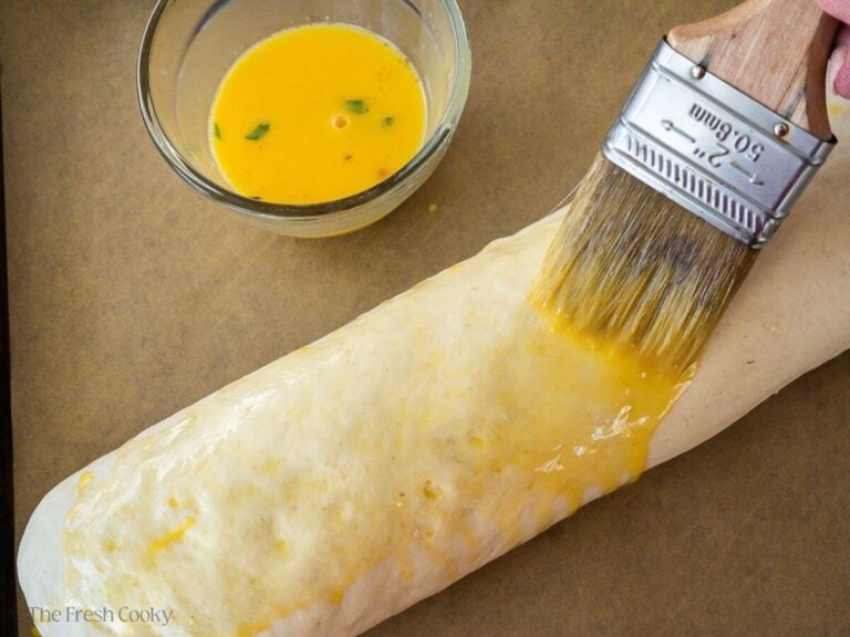 Brushing top with egg wash.