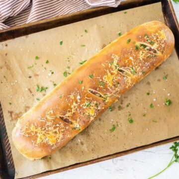Whole stromboli baked on baking sheet.