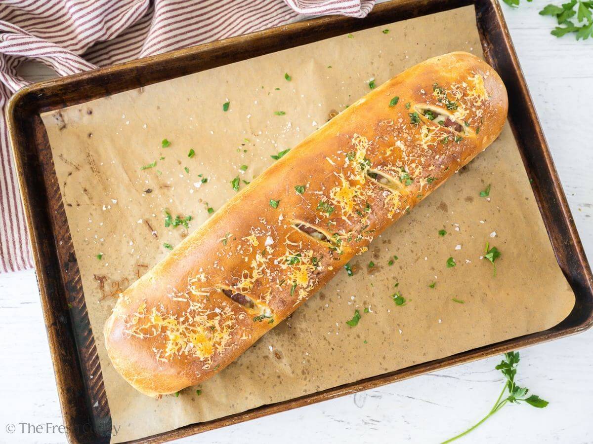Whole stromboli baked on baking sheet.