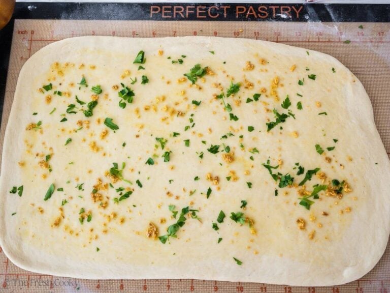 Stromboli dough brushed with garlic oil and sprinkled with parsley.