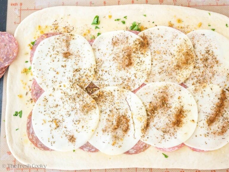 Add provolone and sprinkle with pizza seasoning (Italian seasoning).