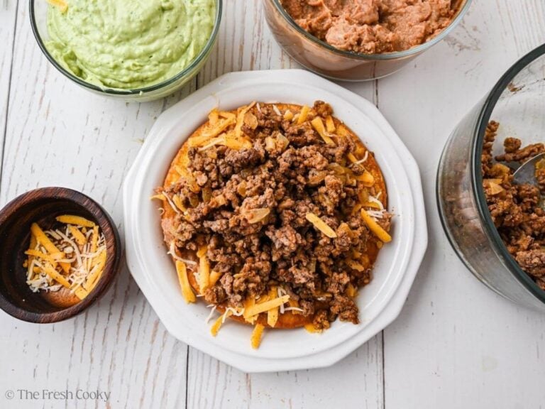 Add ground beef on top of beans.