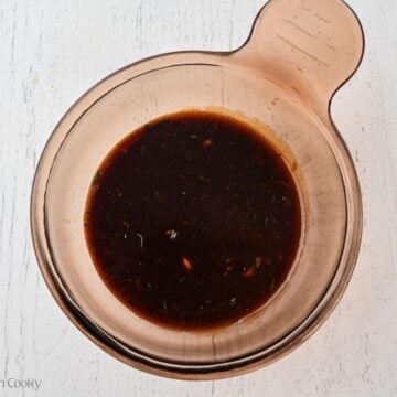 Reserved balsamic marinade in a saucepan to cook.