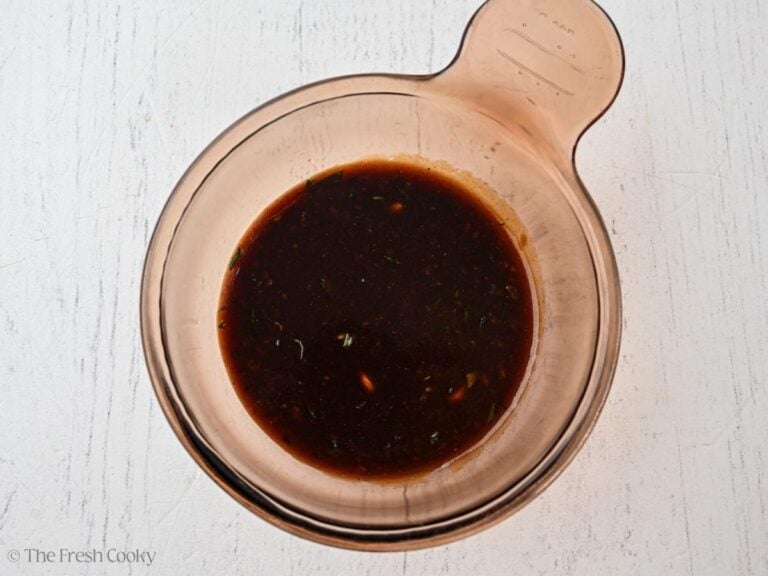 Reserved balsamic marinade in a saucepan to cook.