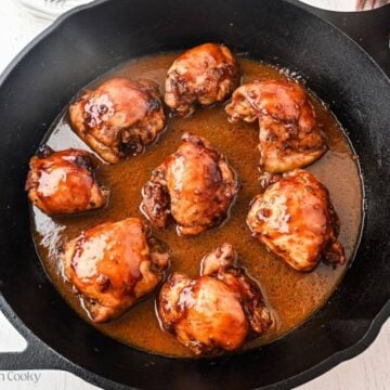 Baked balsamic honey chicken in a cast iron skillet.