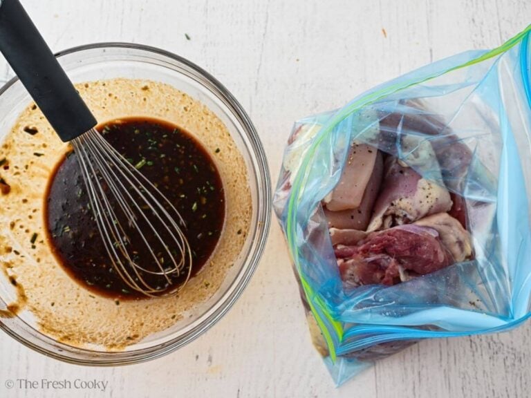 Chicken thighs in a bag next to a bowl of balsamic marinade.