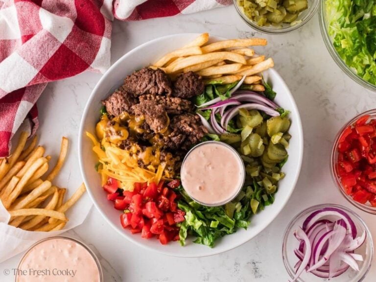 Overhead shot of a homemade burger bowl with fries on the side.