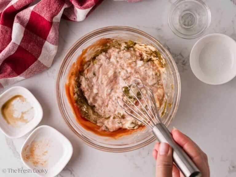 Whisking together the special sauce in a bowl.