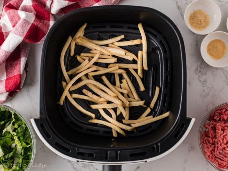 Fries in an air fryer basket.