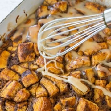 Drizzling glaze with whisk over warm casserole.