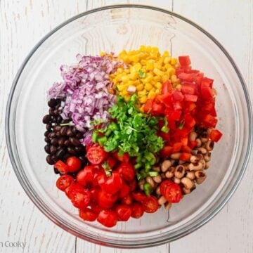 Cowboy caviar ingredients placed in a large bowl.