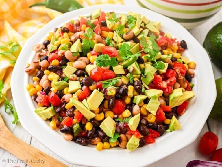 Cowboy caviar in a bowl with avocado, topped with cilantro.