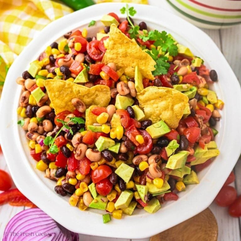Overhead shot of cowboy caviar in a bowl with some tortilla chips in it.