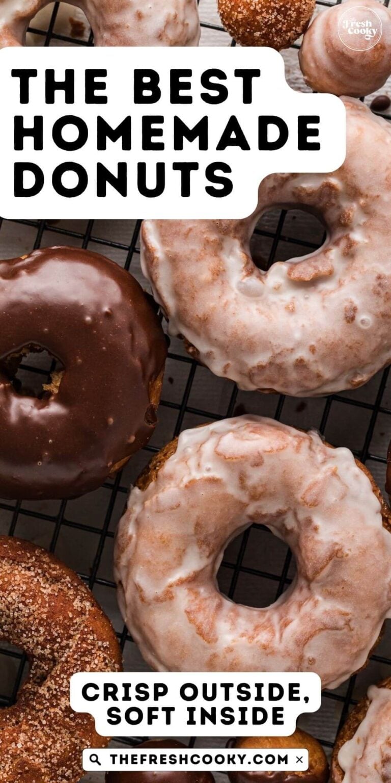 Close up of homemade donuts on a wire rack, with vanilla glaze, chocolate glaze and cinnamon sugar topping, for pinning.