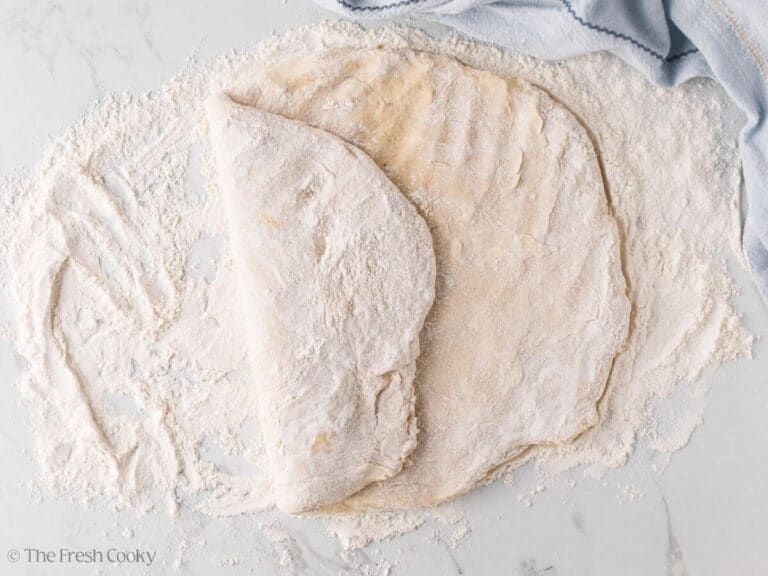 Folding one side of the donut dough over the top.