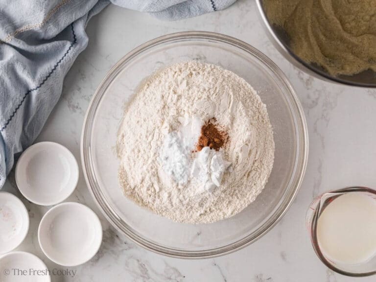Flour, baking powder, baking soda, salt and nutmeg in a bowl.