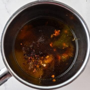 Orange chicken sauce ingredients in a saucepan.