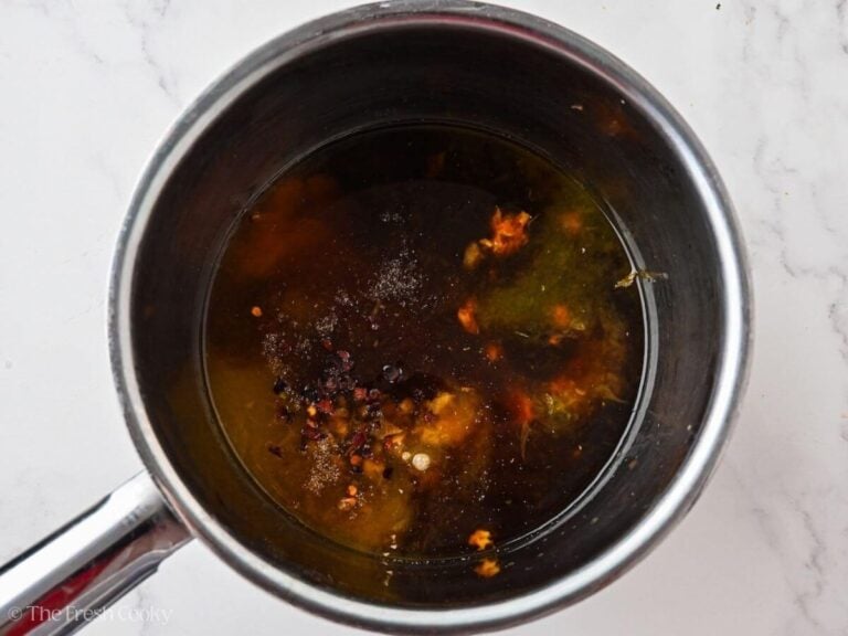 Orange chicken sauce ingredients in a saucepan.
