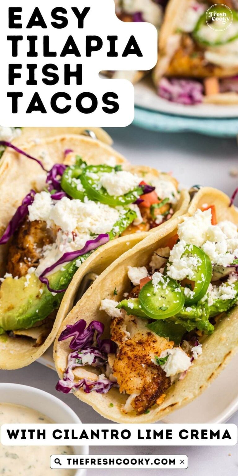 Fish tacos with tilapia in corn tortillas, topped with avocado, coleslaw, cotija cheese and cilantro lime crema, for pinning.