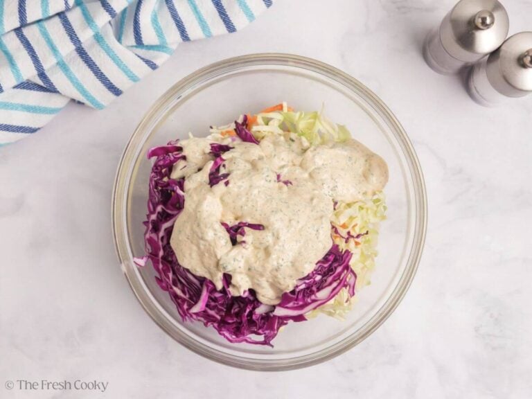 Some of the sauce added to the coleslaw.