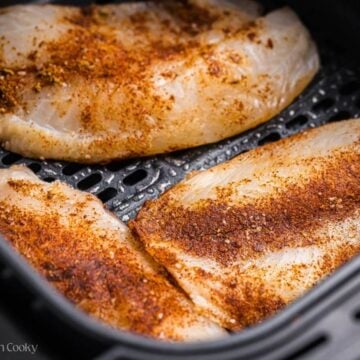 Seasoned tilapia placed in the air fryer.