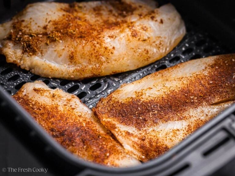 Seasoned tilapia placed in the air fryer.