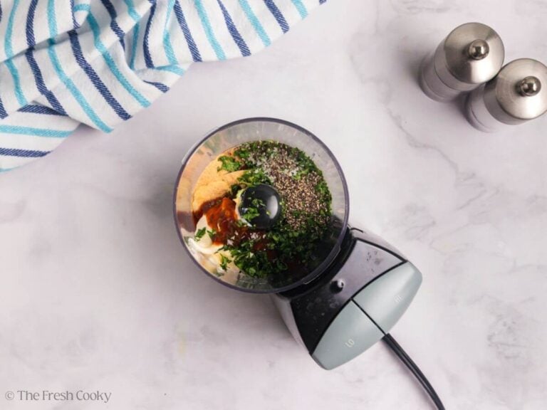 Ingredients needed to make the creamy sauce for tacos in a food processor.