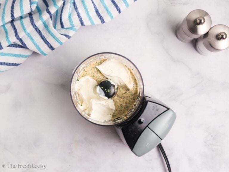 Sour cream added to the sauce ingredients in a food processor.