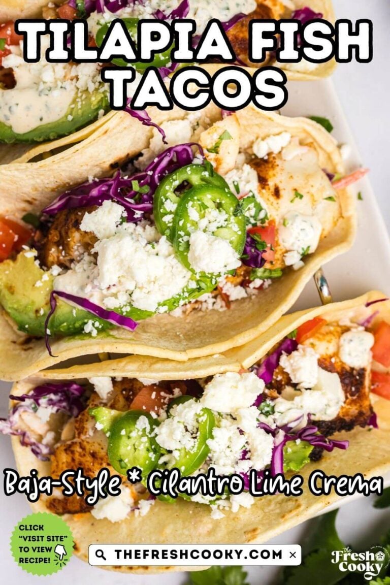 Looking down on tilapia fish tacos in corn tortillas, topped with cotija cheese, tomatoes, crema and avocado slices, to pin.