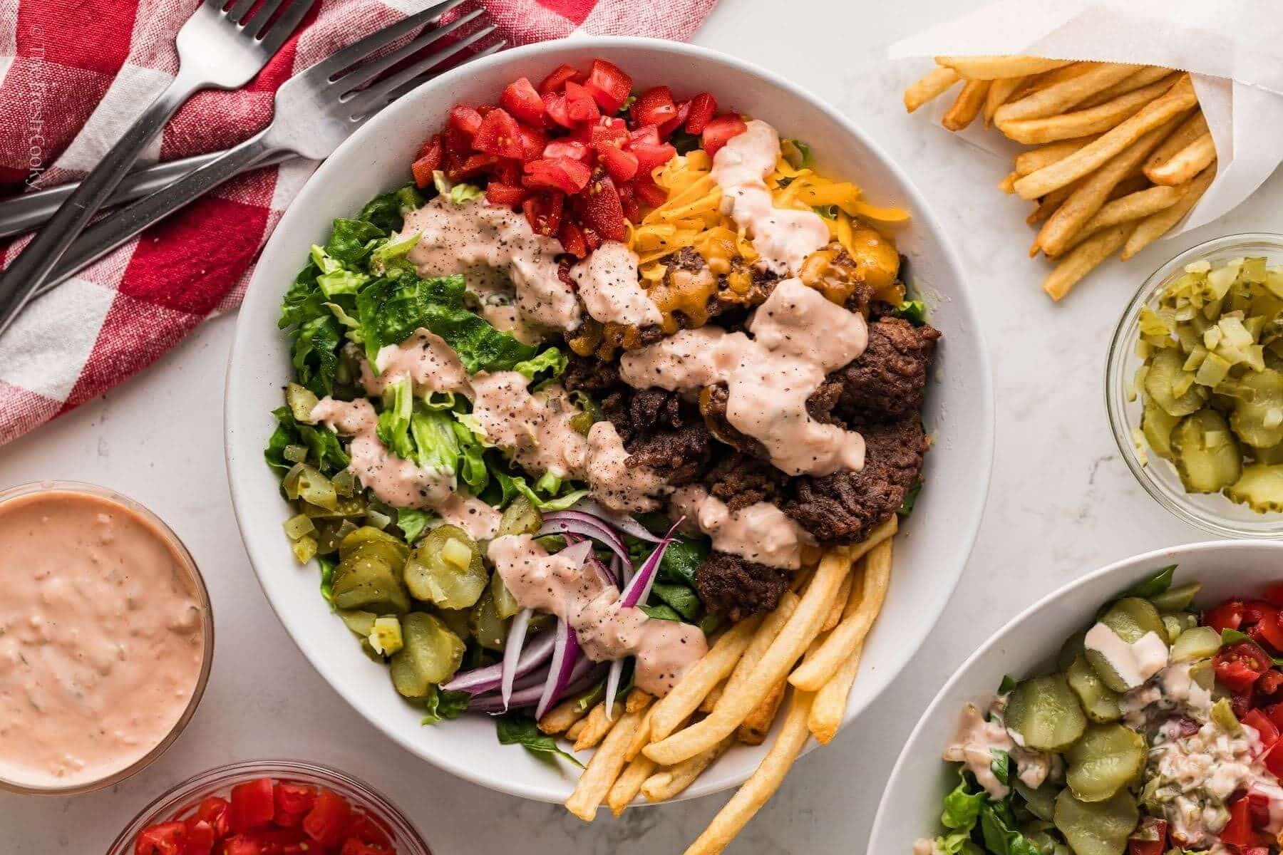 Overhead shot of a burger bowl with special sauce drizzled on top.
