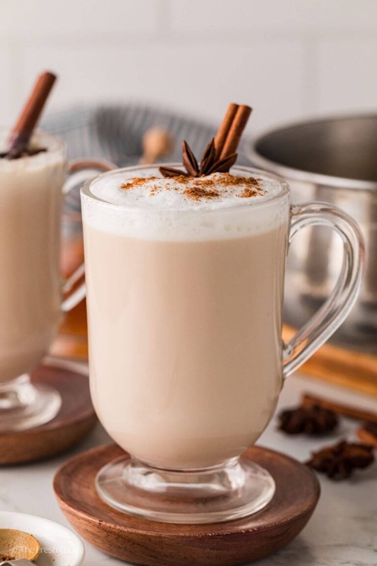 Side view of a chai tea latte in a large glass mug.