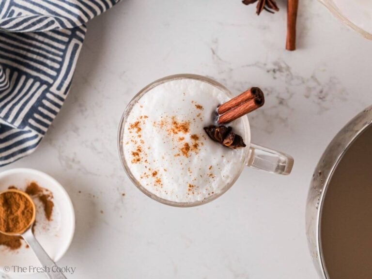 Garnishing a chai latte with cinnamon and star anise.