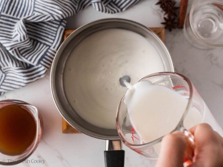 Pouring milk into a saucepan.