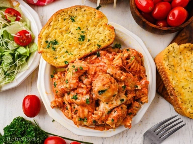Overhead shot of healthy serving of meatball casserole served with garlic toast on a plate.