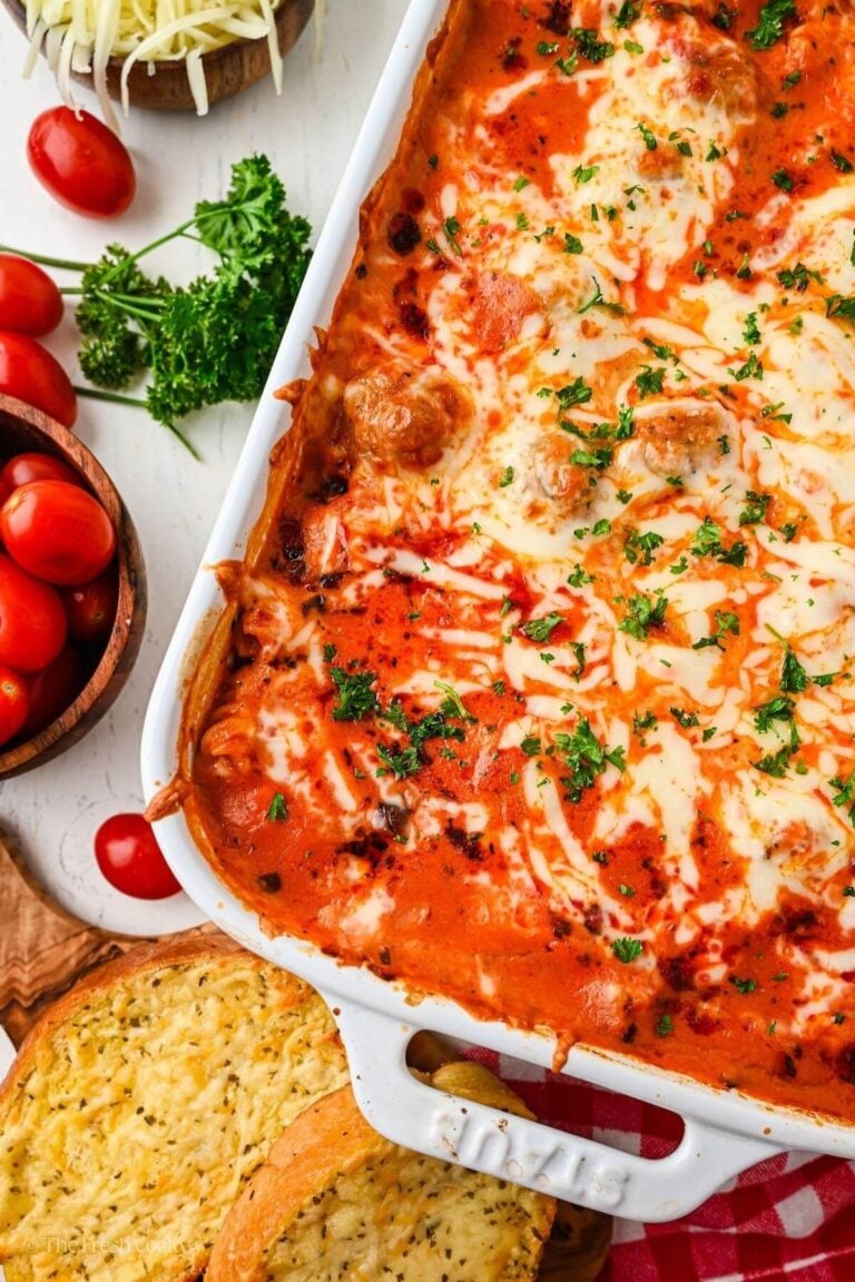 Corner of a dump and bake meatball casserole in a white baking dish.
