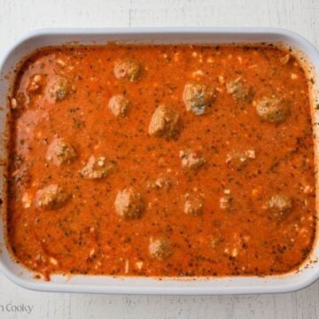 Frozen meatballs added to the baking dish with pasta and sauce.