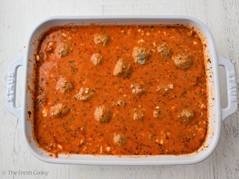 Frozen meatballs added to the baking dish with pasta and sauce.