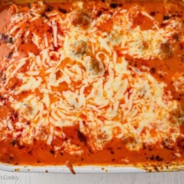 Baked meatball casserole in a white baking dish.