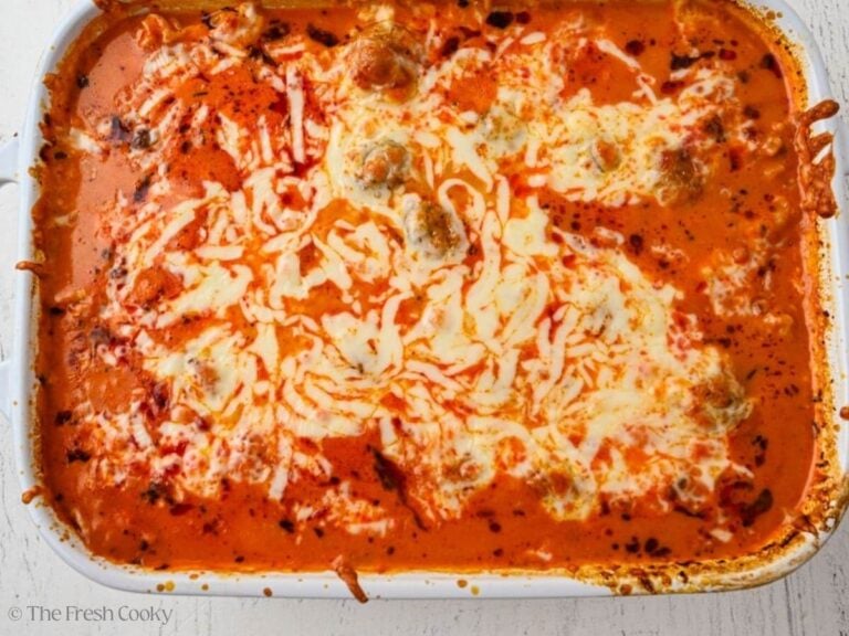 Baked meatball casserole in a white baking dish.
