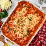 Meatball Casserole in Staub white baking dish with melty cheese on top, a dump and bake dinner.