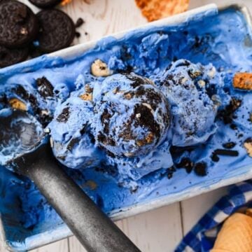 Overhead shot of blue monster ice cream with some scoops of it in a loaf pan.