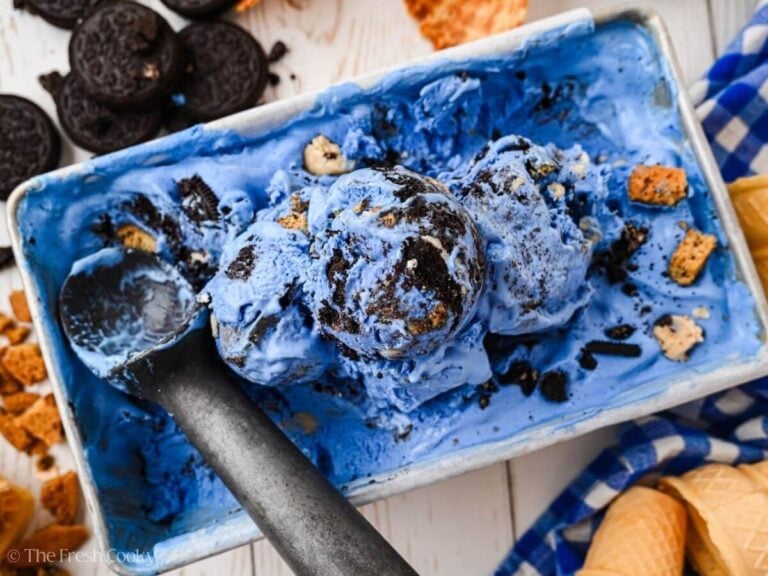Overhead shot of blue monster ice cream with some scoops of it in a loaf pan.
