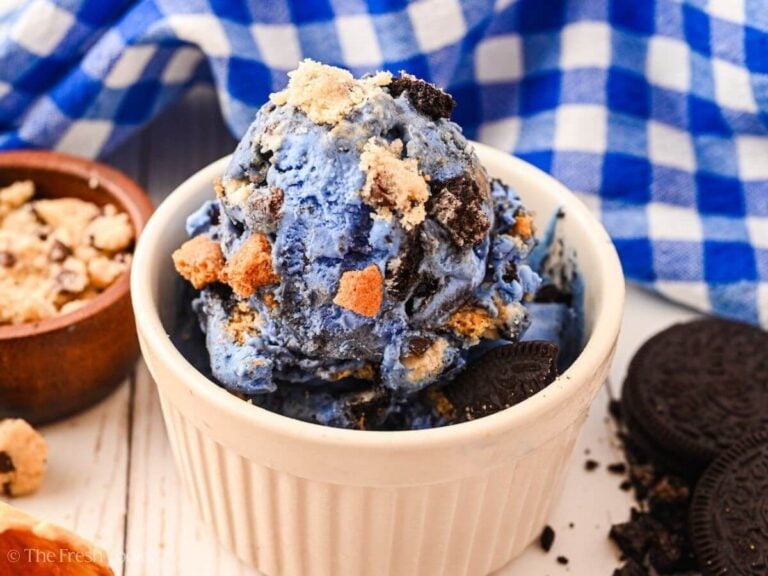 Scoop of blue monster ice cream in a white ramekin.