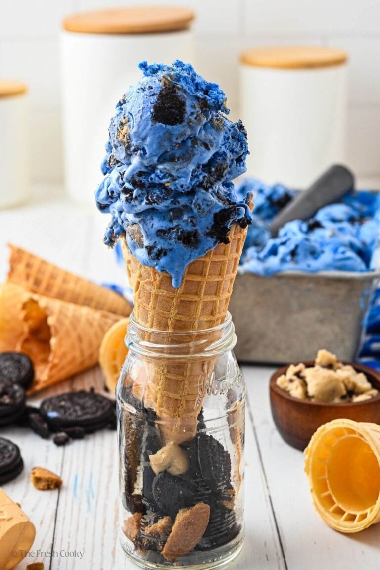 Side view of a cone of blue cookie monster ice cream.