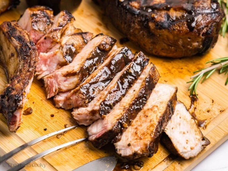 Sliced grilled pork chop on a wooden board.