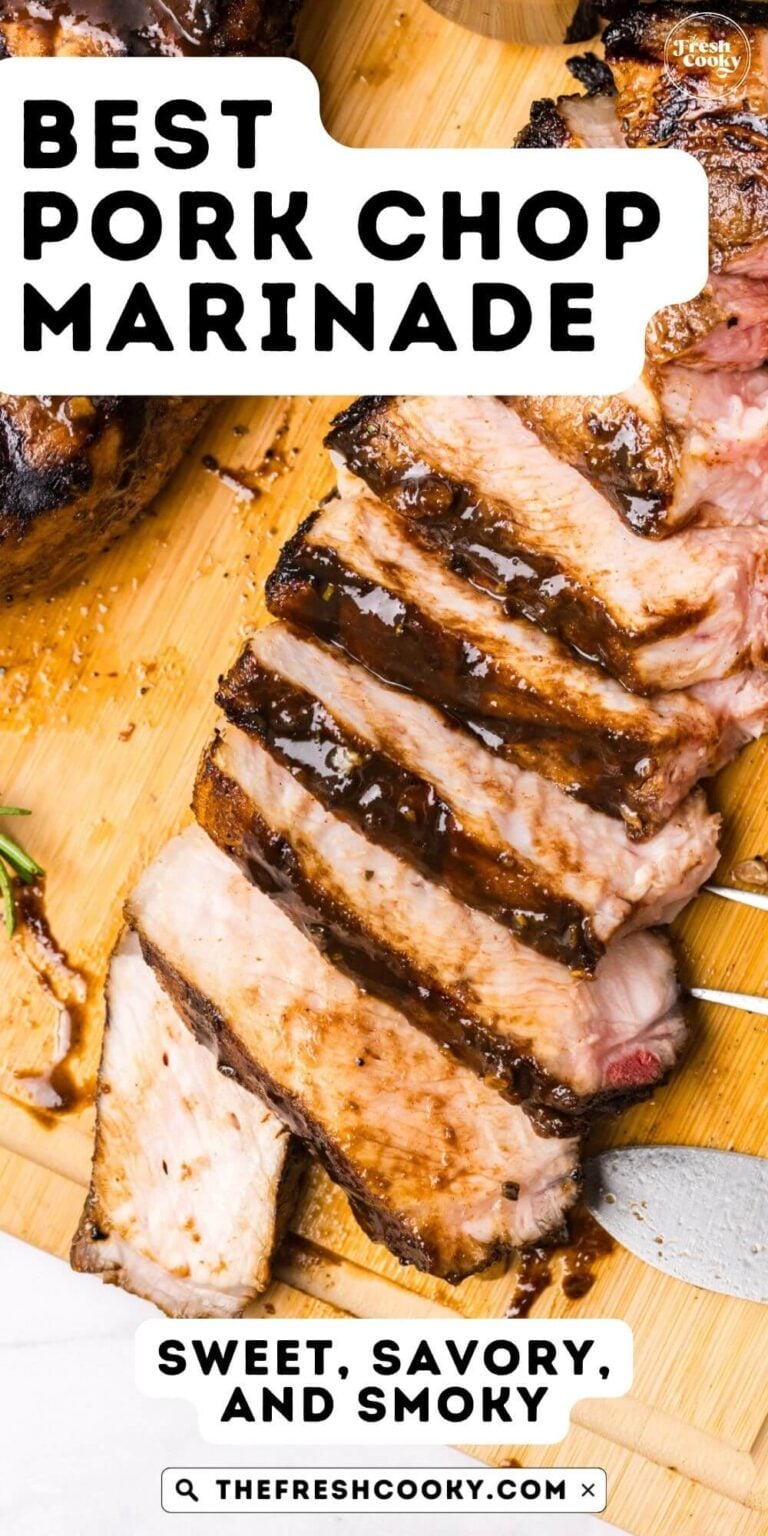 A juicy, sliced pork chop on a cutting board, with a fork nearby, for pinning.