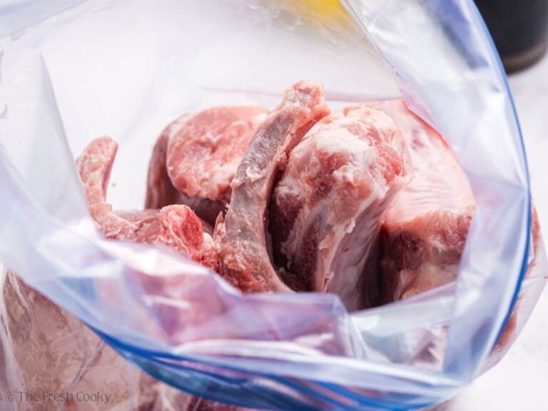 Pork chops placed in a large ziplock bag.